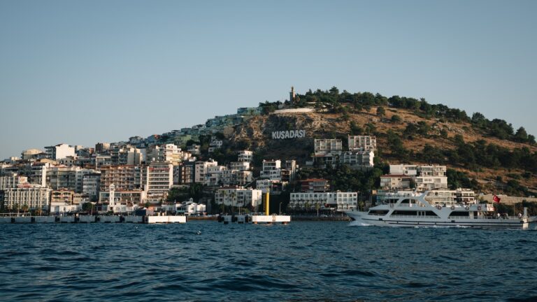 a boat is in the water near a city